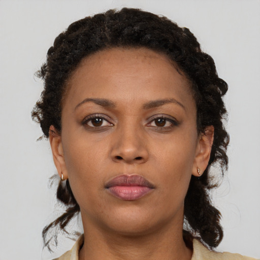 Neutral black young-adult female with medium  brown hair and brown eyes