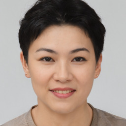 Joyful asian young-adult female with short  black hair and brown eyes