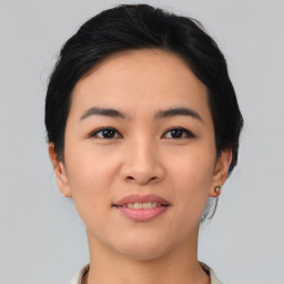 Joyful asian young-adult female with medium  black hair and brown eyes