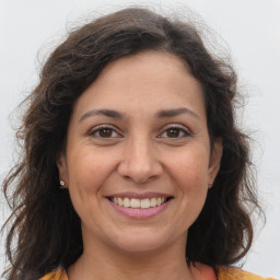 Joyful white adult female with long  brown hair and brown eyes