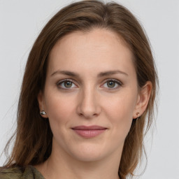 Joyful white young-adult female with long  brown hair and blue eyes