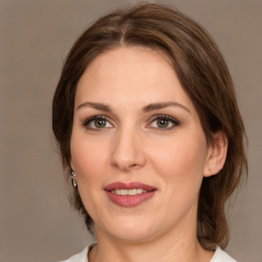 Joyful white adult female with medium  brown hair and brown eyes