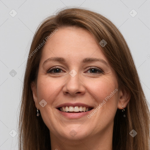 Joyful white adult female with long  brown hair and grey eyes