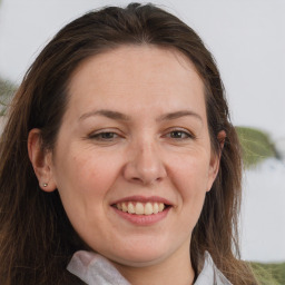 Joyful white adult female with long  brown hair and brown eyes