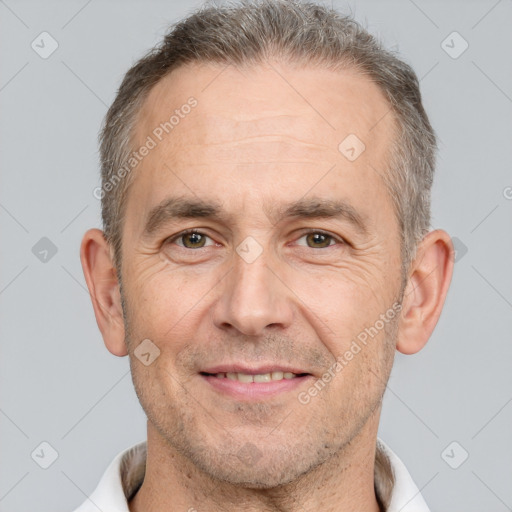 Joyful white adult male with short  brown hair and brown eyes