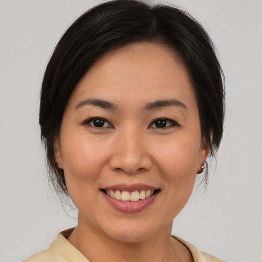Joyful white young-adult female with medium  brown hair and brown eyes
