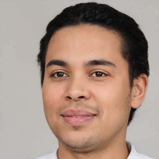 Joyful latino young-adult male with short  black hair and brown eyes