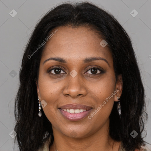 Joyful black young-adult female with long  brown hair and brown eyes