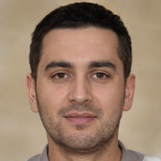 Joyful white young-adult male with short  brown hair and brown eyes