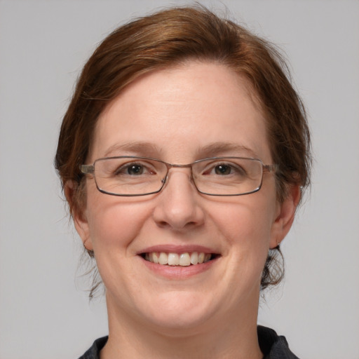 Joyful white adult female with medium  brown hair and blue eyes