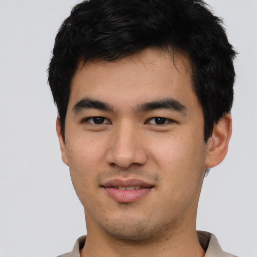 Joyful asian young-adult male with short  black hair and brown eyes