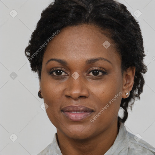 Joyful black adult female with short  brown hair and brown eyes