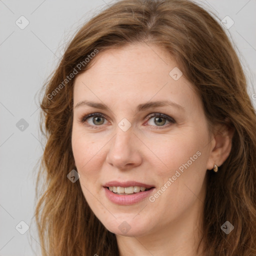 Joyful white adult female with long  brown hair and brown eyes