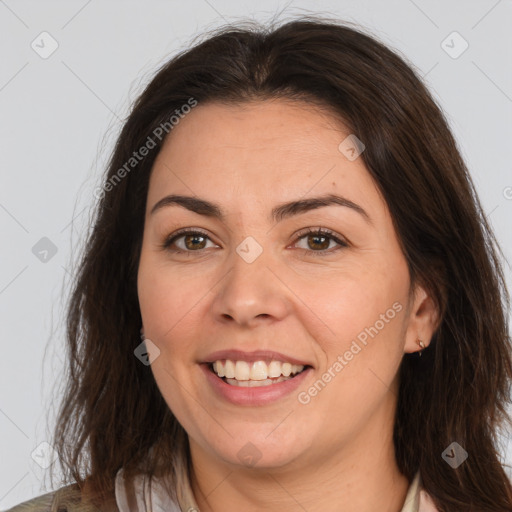 Joyful white adult female with medium  brown hair and brown eyes