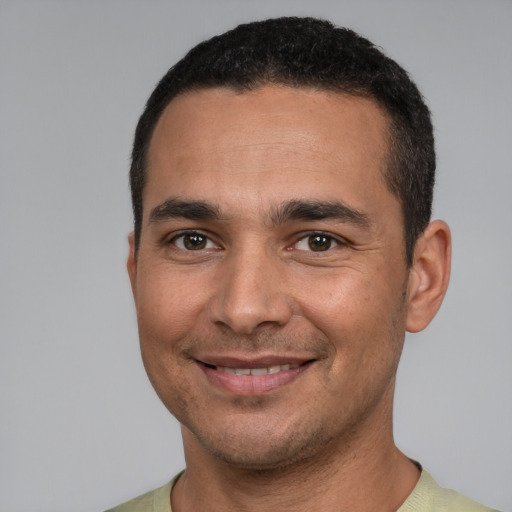 Joyful white young-adult male with short  black hair and brown eyes