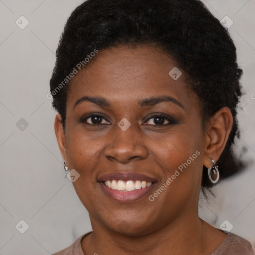 Joyful black young-adult female with short  brown hair and brown eyes