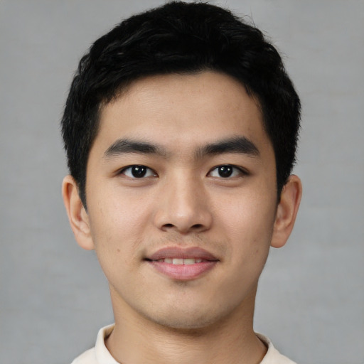 Joyful asian young-adult male with short  black hair and brown eyes
