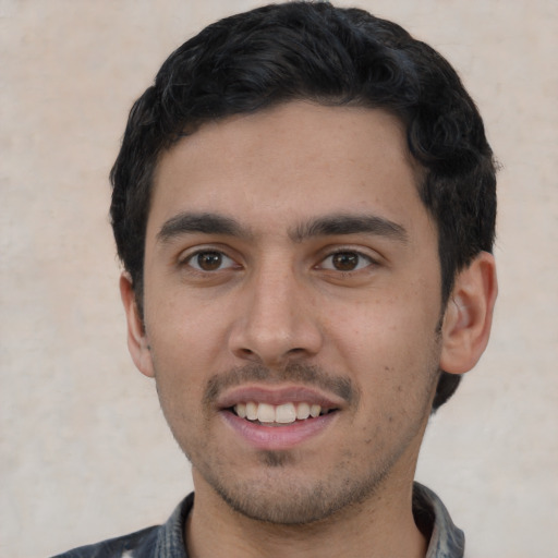 Joyful white young-adult male with short  black hair and brown eyes