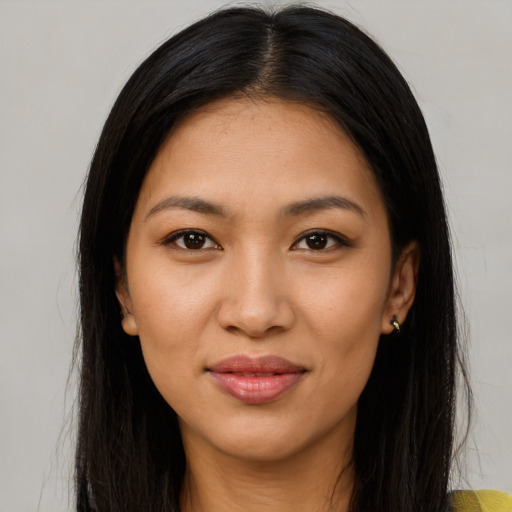Joyful latino young-adult female with long  brown hair and brown eyes