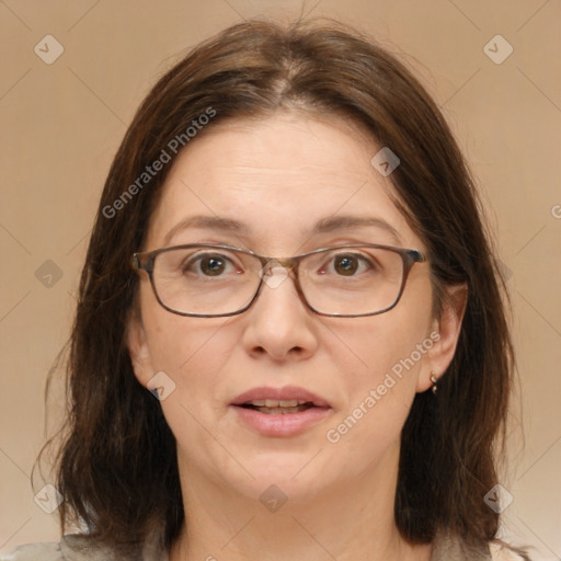 Joyful white adult female with medium  brown hair and grey eyes