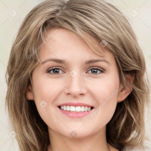 Joyful white young-adult female with long  brown hair and green eyes