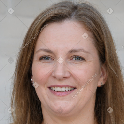 Joyful white adult female with long  brown hair and grey eyes