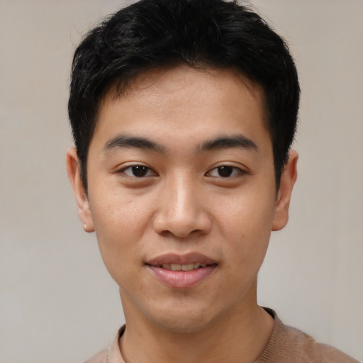 Joyful asian young-adult male with short  brown hair and brown eyes
