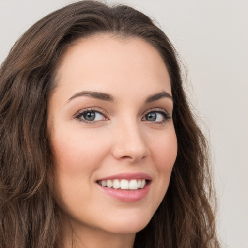 Joyful white young-adult female with long  brown hair and grey eyes