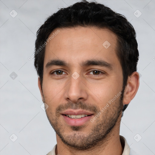 Joyful white young-adult male with short  black hair and brown eyes