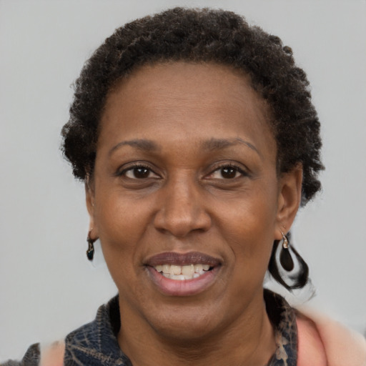 Joyful black adult female with short  brown hair and brown eyes