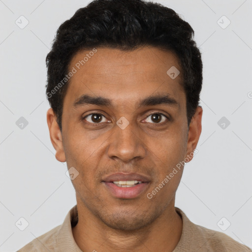 Joyful black young-adult male with short  black hair and brown eyes