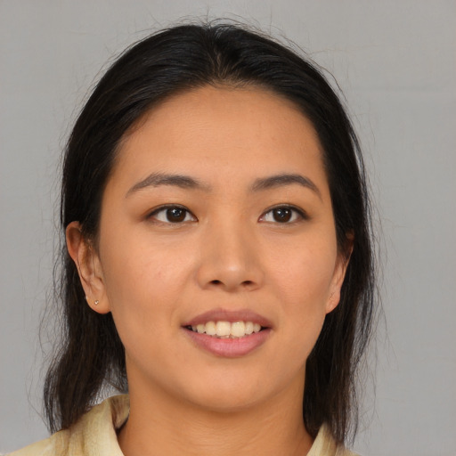 Joyful asian young-adult female with medium  brown hair and brown eyes