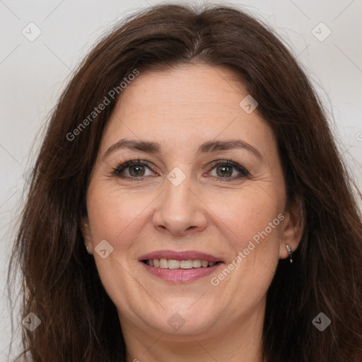 Joyful white adult female with long  brown hair and brown eyes