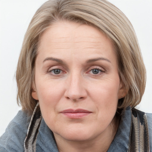 Joyful white adult female with medium  brown hair and blue eyes