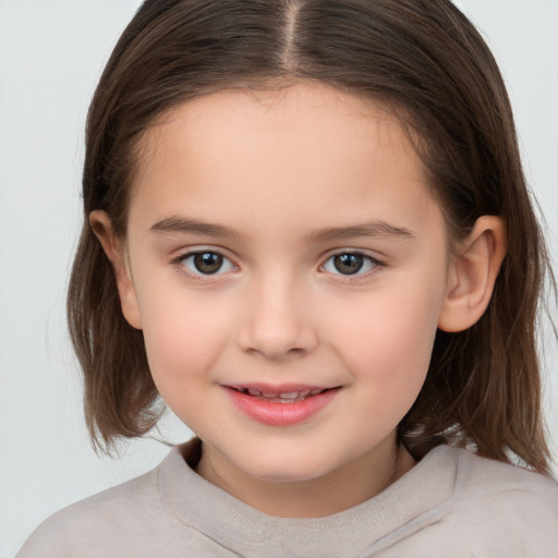 Joyful white child female with medium  brown hair and brown eyes