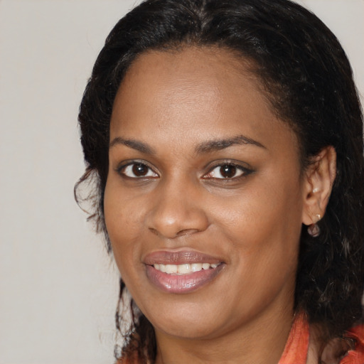 Joyful black young-adult female with medium  brown hair and brown eyes
