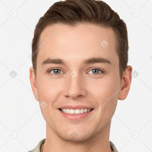 Joyful white young-adult male with short  brown hair and grey eyes