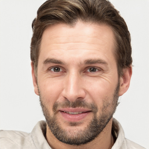 Joyful white adult male with short  brown hair and brown eyes