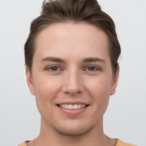 Joyful white young-adult female with short  brown hair and grey eyes