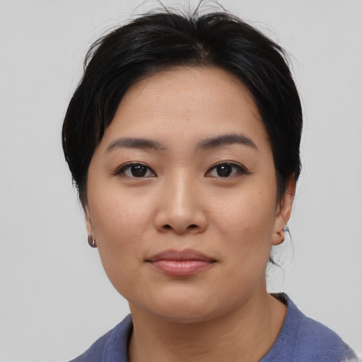 Joyful asian young-adult female with medium  black hair and brown eyes