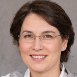 Joyful white adult female with medium  brown hair and brown eyes