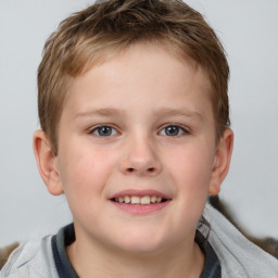 Joyful white child male with short  brown hair and blue eyes