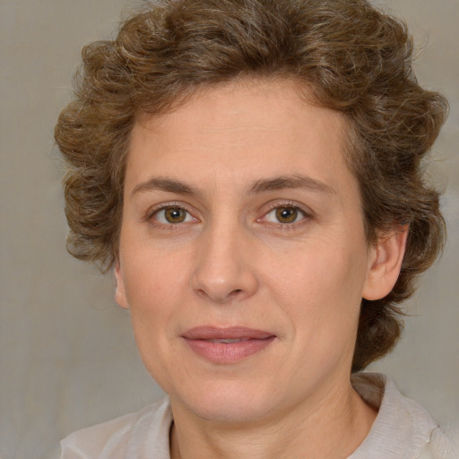 Joyful white young-adult female with medium  brown hair and green eyes