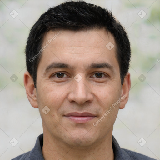 Joyful white adult male with short  black hair and brown eyes