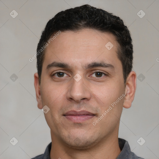 Joyful white young-adult male with short  black hair and brown eyes