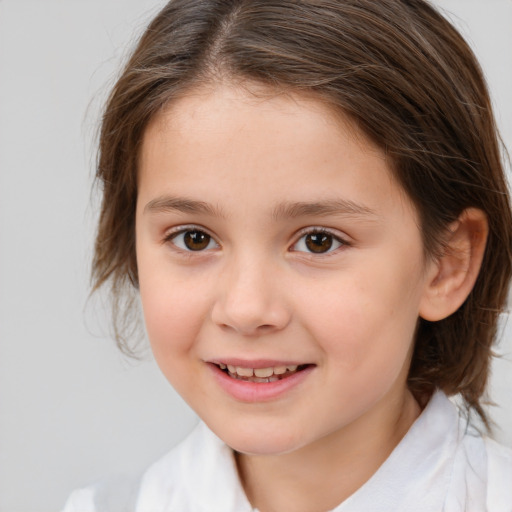 Joyful white child female with medium  brown hair and brown eyes