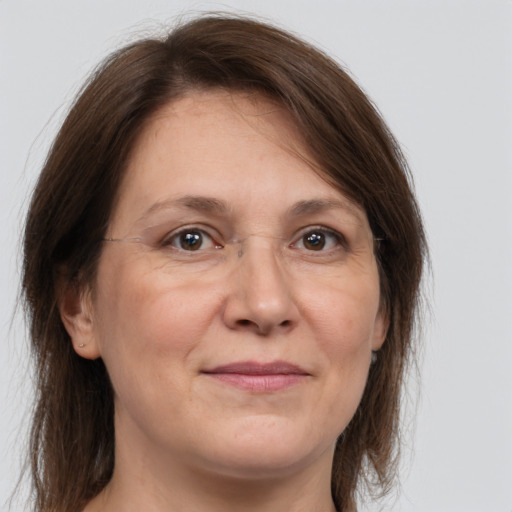 Joyful white adult female with medium  brown hair and brown eyes