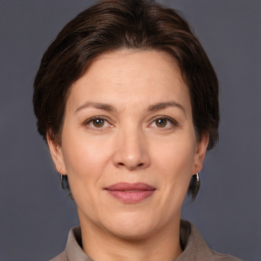 Joyful white adult female with short  brown hair and brown eyes