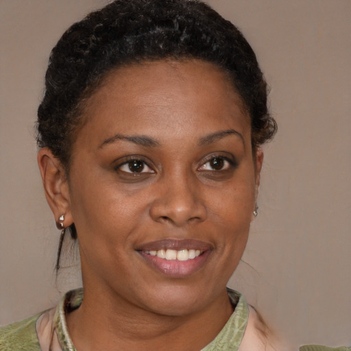 Joyful black adult female with short  brown hair and brown eyes