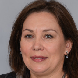 Joyful white adult female with long  brown hair and brown eyes